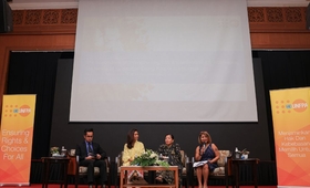 Four speakers in a panel on the stage during the report launch 