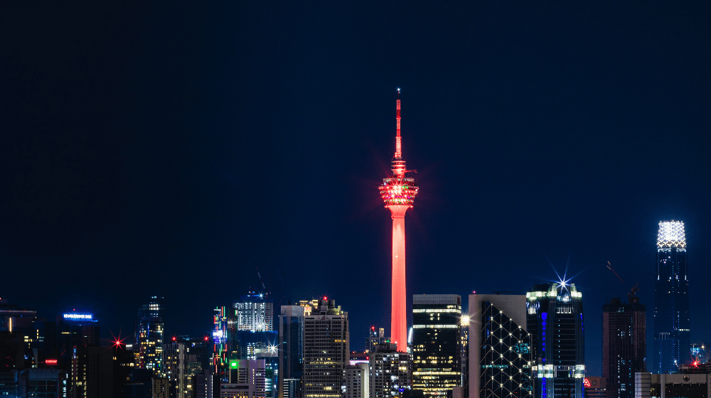 Kuala Lumpur tower lit in orange over the KL skyline