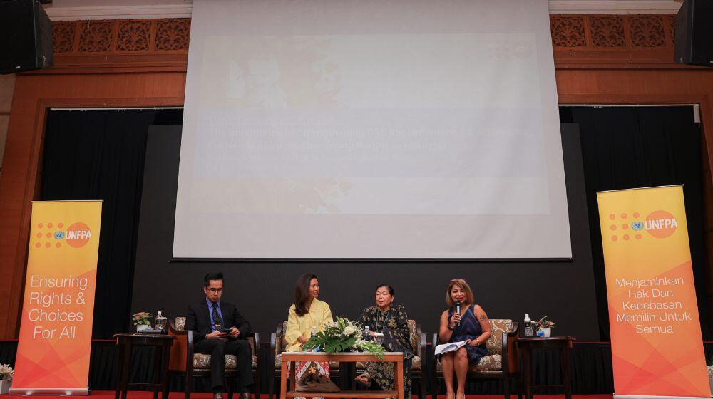 Four speakers in a panel on the stage during the report launch 